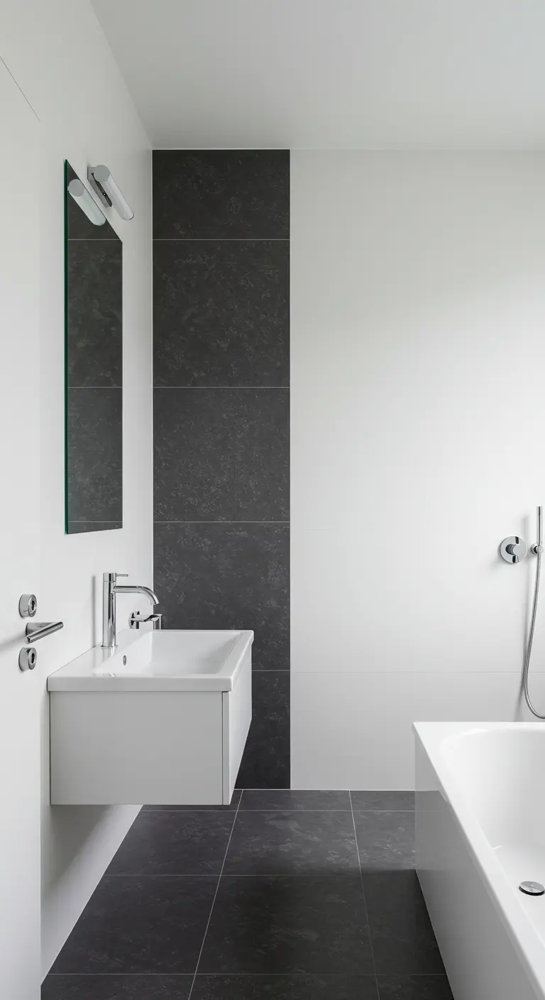Minimalistische witte badkamer met een donkere tegelstrook en een subtiel roze handdoekaccent.