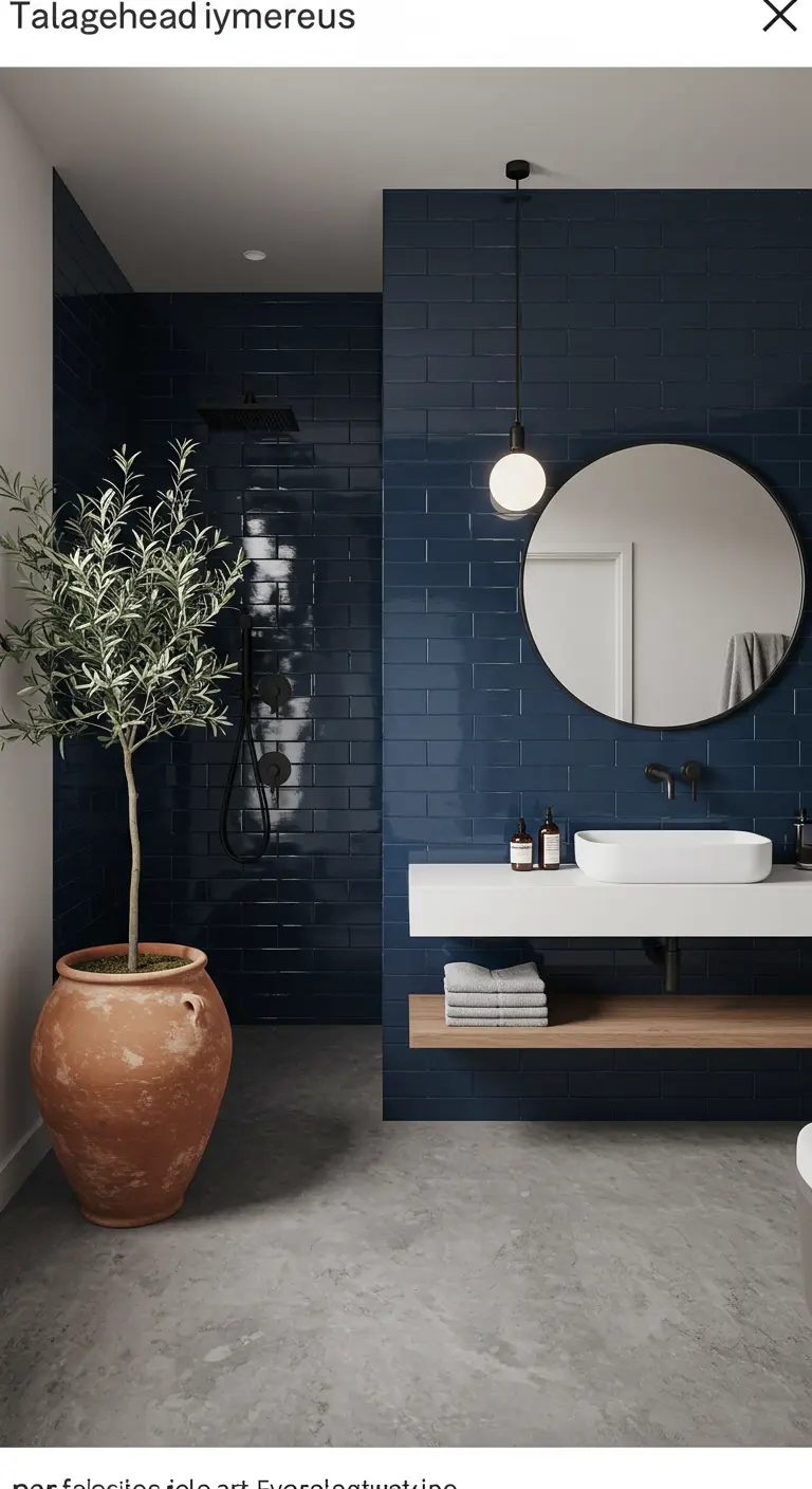Moderne badkamer met donkerblauwe tegels, zwevend meubel en olijfboom in terracotta pot.